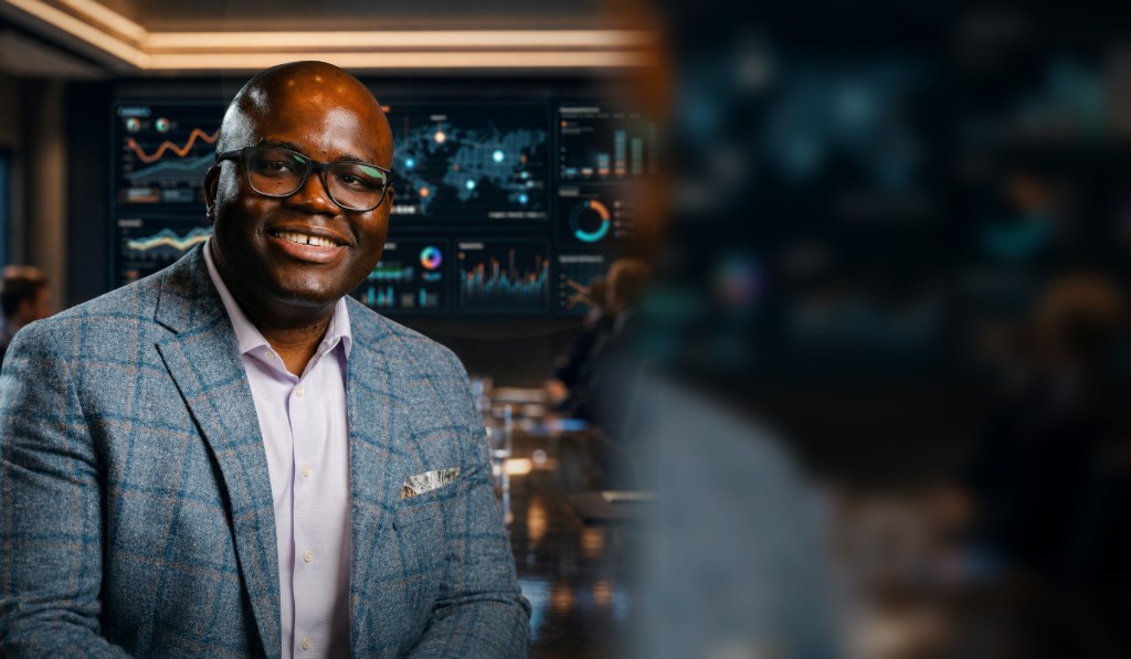 Ade Oridate in an executive decisioning and analytics boardroom environment